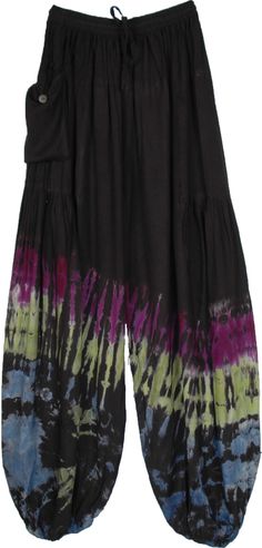 As dark as the night and as vibrant as your mood, these harem pants are a vision.  The dark black background sets the perfect base for the multicolor tie-dye pattern of purple, green, blue, and white. #tlb #SplitSkirtsPants #Yoga #vacationclothing #beachwrap #bohemianfashion #TieDye #Summerpants #HiippiePants #harempants #loungepants Black Cotton Hippie Harem Pants, Black Hippie Bottoms With Elastic Waistband, Bohemian Black Harem Pants With Elastic Waistband, Black Hippie Long Pants, Hippie Style Black Wide Leg Pants, Black Wide Leg Hippie Bottoms, Black Wide Leg Hippie Pants, Black Hippie Harem Pants For Festival, Black Hippie Harem Pants