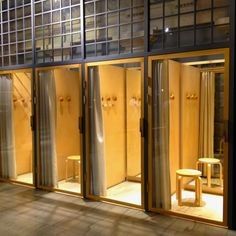 the inside of a building with glass walls and doors that are lit up at night