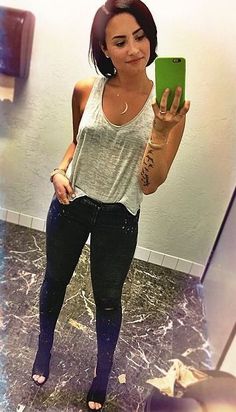 a woman taking a selfie in the mirror with her cell phone and leggings