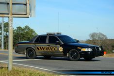 a sheriff car is parked on the side of the road