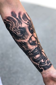 a man's arm with a skull tattoo on it