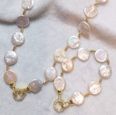 This is an natural-color fresh water button pearl necklace bangle set. Featuring with white colors of pearls. The necklace and the bangle can be combined together and become a long necklace or wear seperately. The pearls with bright rainbow luster which made the bracelet more elegant and beautiful.  It's suitable for any kind of parties and events. Total length is about 65cm and the approximate size of the button pearls are 16~18mm Every item will come with a nice gift box. Item to be delivered from Hong Kong to worldwide with registered airmail. After settle the payment we will ship out in 3-5 business days.  Delivery time:  US- 7-20 days Europe - 8-25 days Asia - 5- 14 days Others 10 - 30 days Customs and import taxes Buyers are responsible for any customs and import taxes that may apply Pearl Bangle With Pearl Charm, Pearl White Bangle With Pearl Charm, White Multi-strand Pearl Charm Jewelry, 14k Gold-filled Pearl Charm Bracelet, Elegant Gold-tone Bracelet With Pearl Charm, Good For Her, Bangle Set, Freshwater Pearl Necklaces, Pearl Jewelry