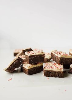 several pieces of brownie with white frosting and sprinkles on top