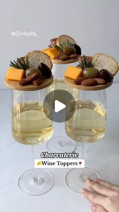 two wine glasses filled with white wine and cheese