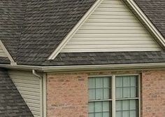 an image of a house with a clock on the front door and two birds perched on the roof