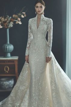 a woman in a wedding dress with long sleeves