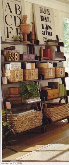 the shelves are filled with baskets and books