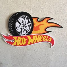 a hot wheels decal on the side of a wall with flames coming out of it