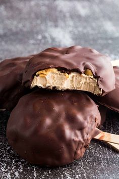 three chocolate covered peanut butter pops on top of each other with one bite taken out