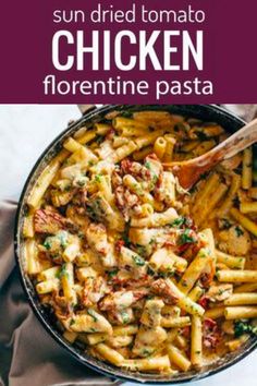 chicken florentie pasta in a skillet with a wooden spoon on the side