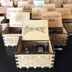 several wooden music boxes sitting on top of a table