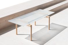 a white table sitting on top of a wooden floor