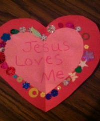 a paper heart with the words jesus loves me written on it