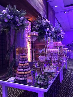 a table topped with lots of cakes and desserts