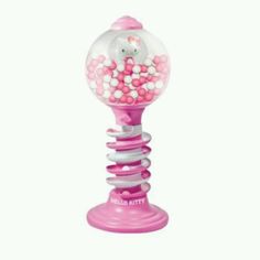 a pink gummy machine with hello kitty on top and lots of balls in it