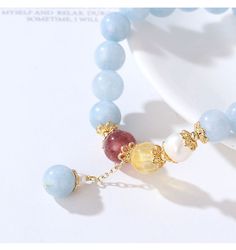 This elegant color stone bead bracelet features light blue aquamarine beads, 7 mm bead diameter, with a dangle drop bead, gold metal bead cap as an accent, on elastic band for easy fitness. Add this elegant bead bracelet to your everyday fashion jewelry collection or as gift for your love one. Jewelry Care: See more information about how to care for your jewelry here. Shipping Policy: Orders will be shipped within 1-3 business days. Economy shipping will take 7-14 days to arrive and standard shi Elegant Light Blue Jewelry With 8mm Beads, Elegant Charm Bracelet With Round Beads For Healing, Elegant Aquamarine Beaded Bracelets, Easy Fitness, Metal Bead, Aquamarine Beads, Elegant Color, For Your Love, Drop Beads