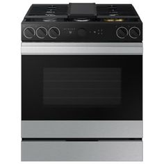 an oven with the door open and its lights on, in front of a white background