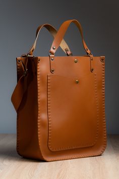 Our handcrafted bag is made from premium Italian leather in a warm ginger color - with a big love and passion! ❤️ ⚒ It features a magnet and adjustable strap, combining style and practicality.  ✔️The design allows it to be worn both on the shoulder and carried by hand, offering versatile carrying options for any occasion. Each bag from our store - is unique, making it a one-of-a-kind accessory. ⚒ About the Bag: *Size: 36x30x15 cm *Color: Ginger *Material: Italian Leather *Lock Type: Magnet World Leather Bag Aesthetic, Big Hand Bag, Unique Leather Bag, Ginger Color, Woman Bag, Favorite Handbags, Handcrafted Bags, Produce Bags, Leather Handbags Women