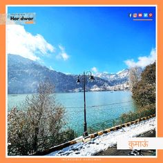 an image of a lake with mountains in the background and snow on the ground around it