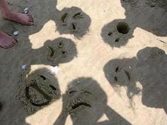 several people are standing in the sand with their footprints