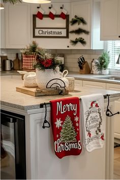 two christmas towels hanging on the kitchen counter