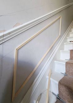 an empty staircase with white walls and beige carpet