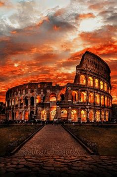 the colossion at sunset is lit up with bright lights and clouds in the background