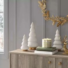 white and gold christmas decorations on a dresser