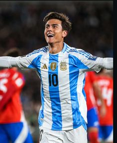 a soccer player with his arms out in celebration