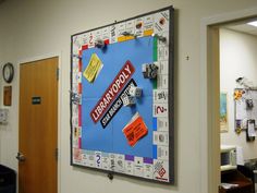 a bulletin board that has been decorated with stickers on it in an office hallway