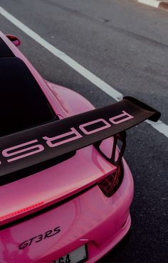 a pink sports car with the word porsche on it's tailpipe and license plate