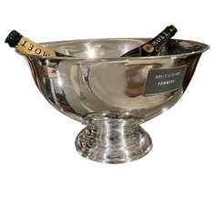 two bottles of champagne in a silver bowl