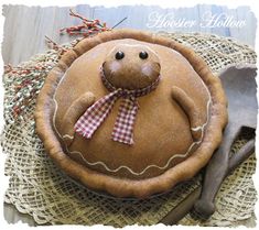 a brown teddy bear sitting on top of a pie