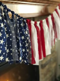 the american flag is hanging on a clothes line in front of an open fire place