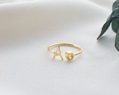 Our Letter Ring is made of high quality materials and has an elegant design. Each birthstone represents a particular month of birth and these stones are associated with love, luck and special meanings. Birthstone silver letter rings are finished with a birthstone representing your birth month. Each birthstone reflects your personality and energy. These rings emphasize the natural beauty and uniqueness of you or your loved ones. Thanks to the gold plated and rose gold plated options, you can choo Initial Ring With Bezel Setting As Gift, Citrine Birthstone Ring For Anniversary, Adjustable Yellow Gold Initial Ring With Birthstone, Adjustable Initial Ring In Yellow Gold With Birthstone, Anniversary Citrine Birthstone Ring With Bezel Setting, Sterling Silver Initial Ring With Birthstone, Sterling Silver Initial Ring With Birthstone For Gift, Gold Peridot Birthstone Ring For Anniversary, Dainty Peridot Birthstone Ring For Gift