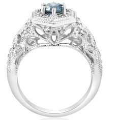 a blue and white diamond engagement ring with an intricate design on the side, set in 18k white gold