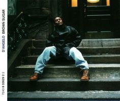 a man sitting on steps in front of a building