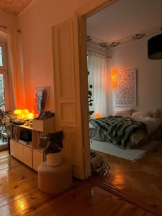 an open door leading to a bedroom with wood floors