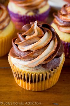 a cupcake with chocolate frosting and apple slices