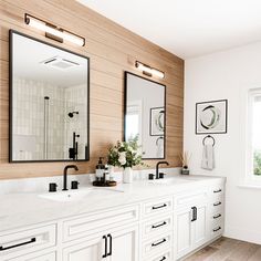 a large bathroom with two sinks and mirrors on the wall next to each other in front of a window