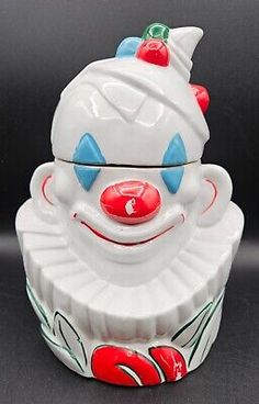 a white clown cup with red nose and blue eyes