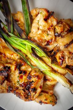 grilled chicken and asparagus on a white plate