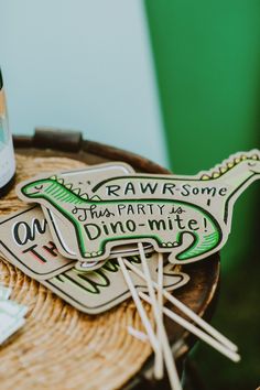 there is a bottle and some stickers on top of the table with drinks in it