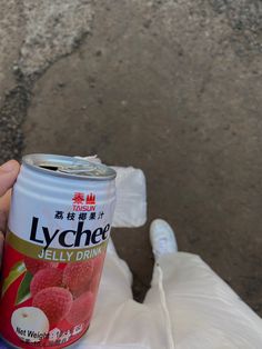 a can of lychee jelly drink in someone's hand