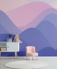 a living room with a pink chair and a blue wall painted in pastel shades