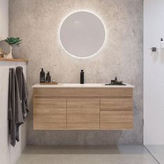 a bathroom with a sink, mirror and towel rack on the wall next to it