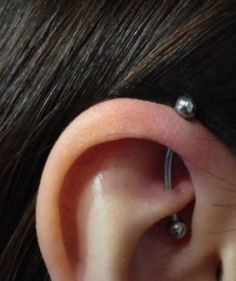 an ear with two piercings attached to it