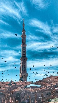 a large tower with birds flying around it