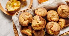 a basket filled with muffins on top of a table next to plates of food