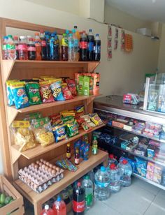 a store filled with lots of different types of food and drinks on shelves next to each other